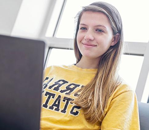 A girl works on her laptop at a regional campus